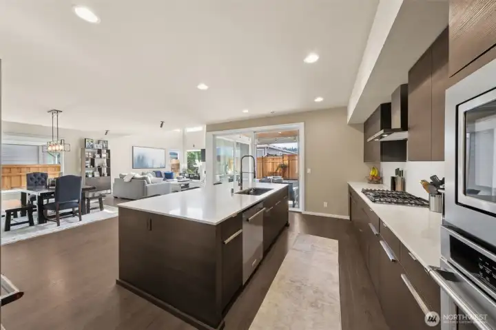 View of dining, great room and covered deck from kitchen