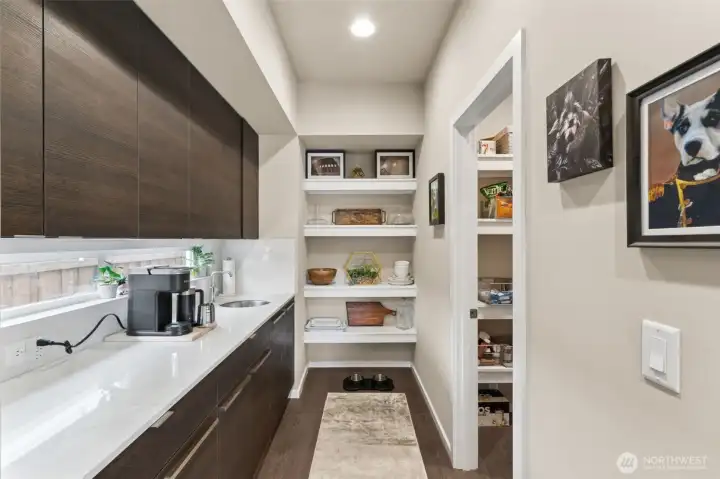 Butler's pantry with prep sink and walk in pantry to the right
