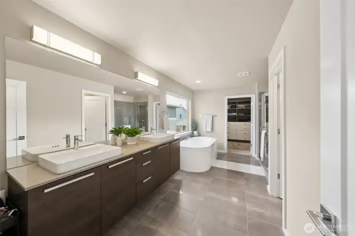 Primary bath with second walk in closet in the distance