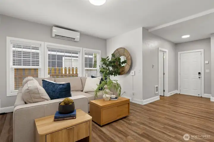 Another view of the living room to the 1/2 bath/laundry and garage entry door.