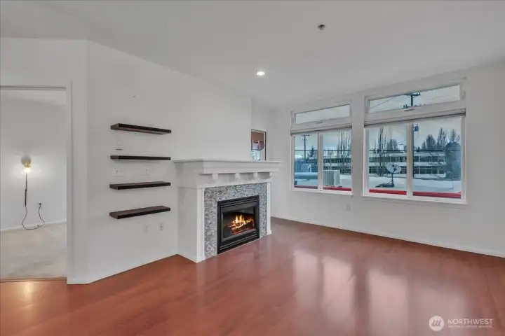 Tall ceilings grace the home, living room with electric fireplace and and door out to the 2nd deck!
