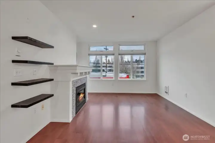 Tall ceilings grace the home, living room with electric fireplace and and door out to the 2nd deck!