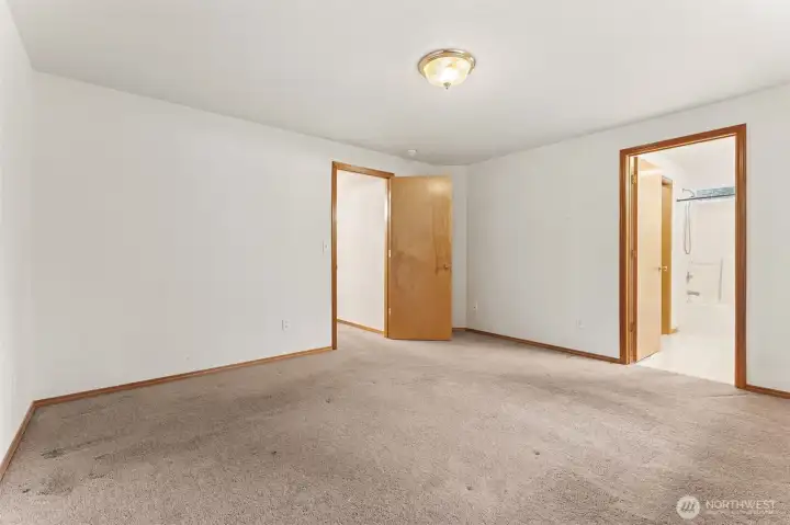 Here is another view of the spacious Primary Bedroom with the attached full bath and the walk in closet through the bathroom.  Easy living.