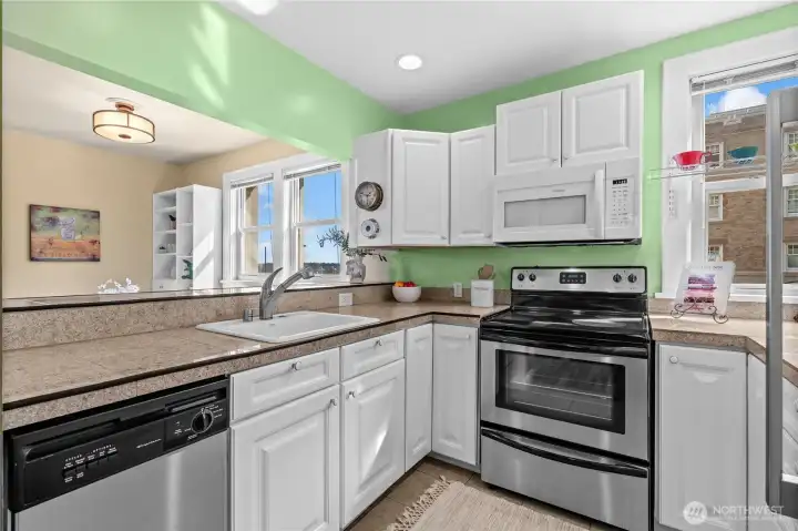 Kitchen looking into dining & living area - partial views of the bay & Stadium HS