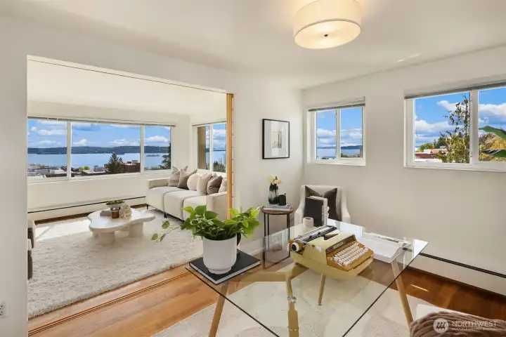 2nd bedroom shown as a home office — generous in size with a large closet, hardwood floors, baseboard heat, and a window with treetop and neighborhood views toward Queen Anne. Freshly painted interior throughout. Hadley House is a co-op — residents are shareholders, governed by an elected Board of Trustees.