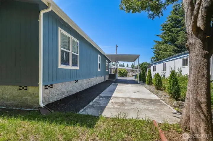 Ample parking is provided with a carport and additional driveway space.