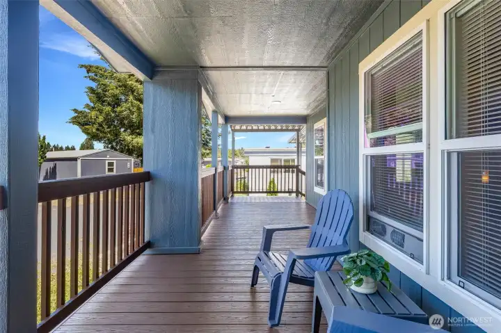 Unwind on the spacious covered front porch, featuring freshly painted balusters and a durable Trex deck, all illuminated by elegant recessed lighting for a perfect outdoor experience.