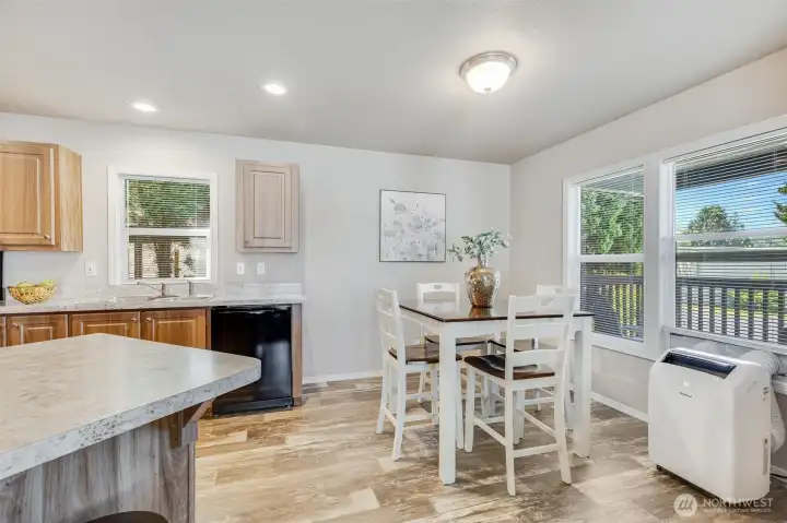 The cozy dining area adjacent to the kitchen provides the perfect spot for meals and intimate gatherings.