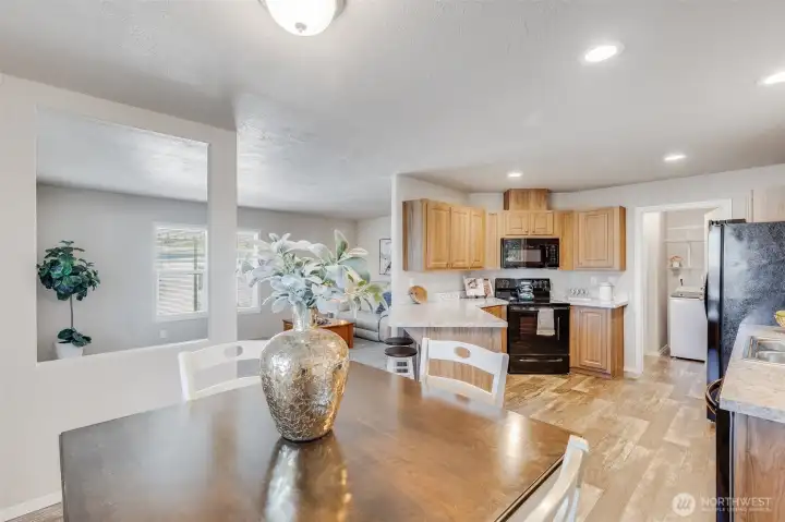 Imagine preparing meals in this modern eat-in kitchen, complete with elegant wood cabinetry, a convenient breakfast bar, and modern appliances.