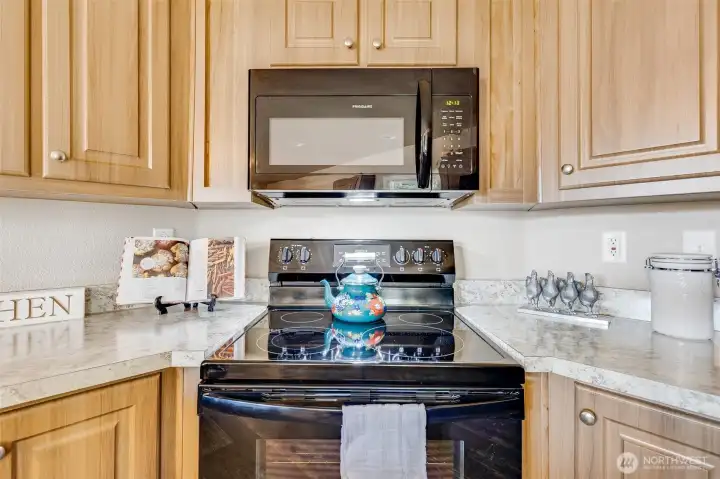 Tons of counter and storage space in the kitchen ensure all your culinary essentials are within easy reach. Electric glass top range/oven and built-in microwave make cooking a breeze.