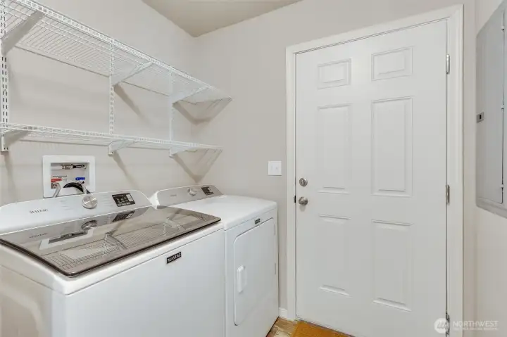A practical utility room comes equipped with a newer washer and dryer, making laundry day a breeze.