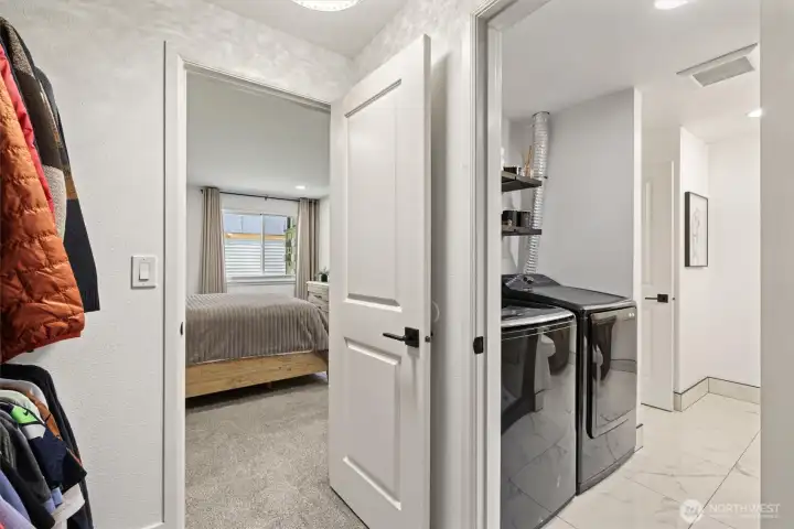 Walk-in closet, laundry area, and an adjoining bathroom.