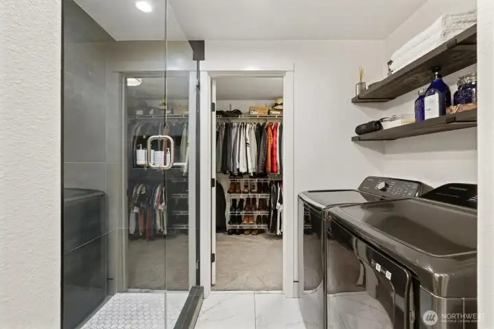 Walk-in closet, laundry area, and an adjoining bathroom.