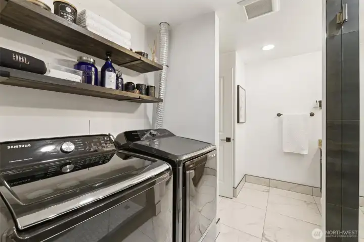 Walk-in closet, laundry area, and an adjoining bathroom.