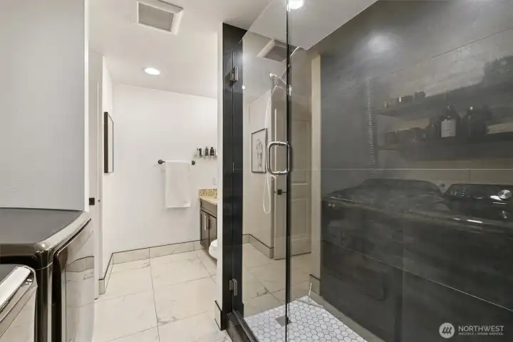 Walk-in closet, laundry area, and an adjoining bathroom.