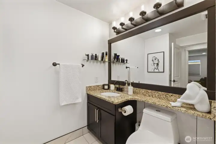 Walk-in closet, laundry area, and an adjoining bathroom.