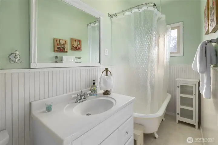 Full bath! Charming clawfoot tub with shower unit.
