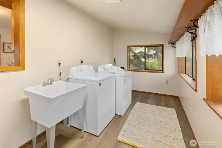 BIG Laundry room with utility sink. Washer & Dryer stay. Lots of room for additional storage.
