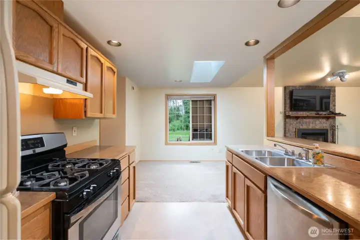 A very functional galley kitchen with ample counter space open to the dining & living room.