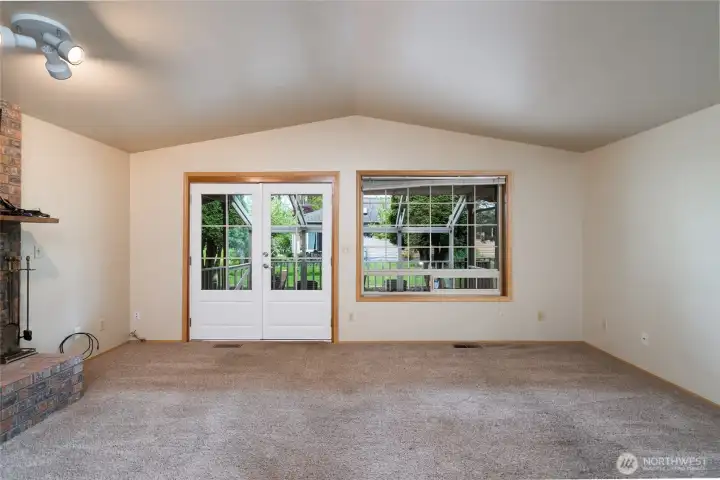 The living room with a French door leading to covered, exposed aggregate patio perfect for outdoor gatherings.
