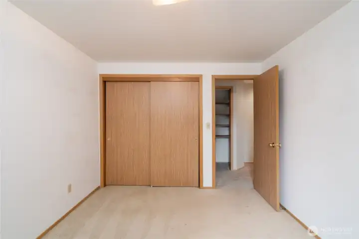 Second bedroom located at the end of the hallway with a backyard view.