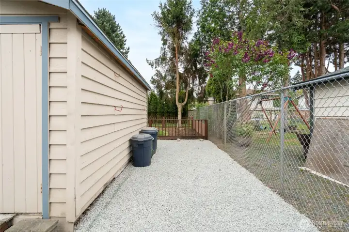 Low-maintenance gravel borders the storage sheds and extends to the driveway for additional RV/boat/trailer parking.