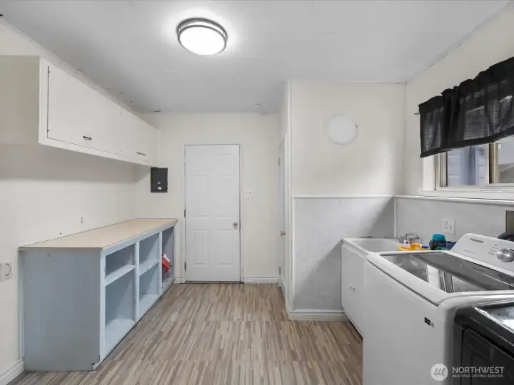 Over sized laundry room. Could also be a pantry. Half bath behind door on the right. Plenty of room & with water right there, easy enough to add a shower and make it a 3/4 bath. So many options on this end of the home!! Over sized laundry room. Could also be a pantry. Half bath behind door on the right. Plenty of room & with water right there, easy enough to add a shower and make it a 3/4 bath. So many options on this end of the home!!