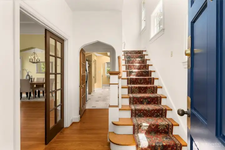 Step inside to timeless craftsmanship, soaring ceilings, original hardwoods, and graceful archways.