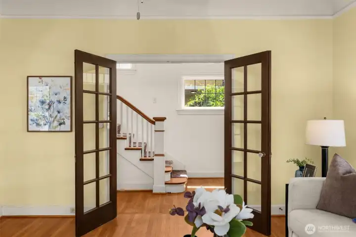 Classic French doors create an effortless flow between elegant living and entry.