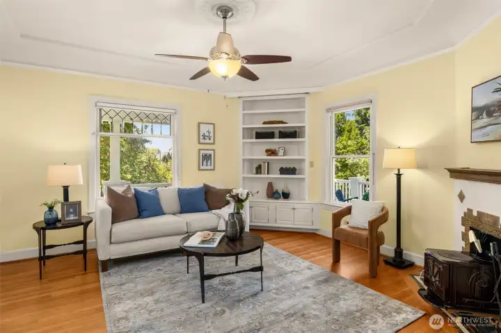 Light-filled living room with hardwood floors blends historic charm with everyday comfort.