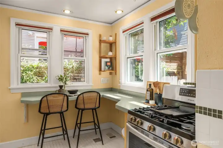 Sweet breakfast bar takes advantage of the garden view below.
