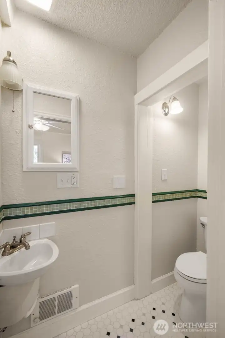 Creative corner sink adds a vintage touch to this main-floor half bath
