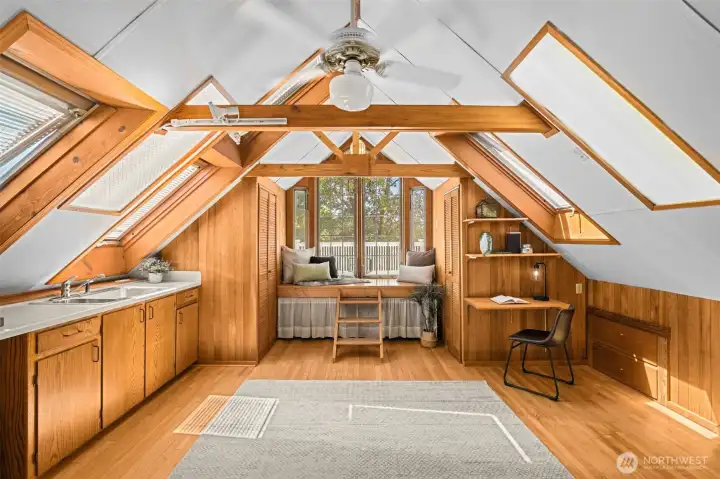 Third floor attic space - one of the many highlights of this home. Write a book at the small desk space and then enjoy reading it in the window seat, enjoying glimpses of downtown Seattle from your perch.