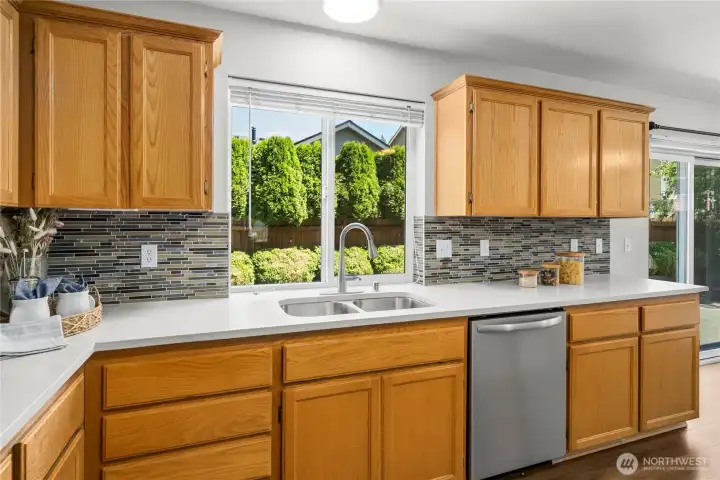 A picturesque window overlooks the serene backyard, creating a calming connection to the outdoors.