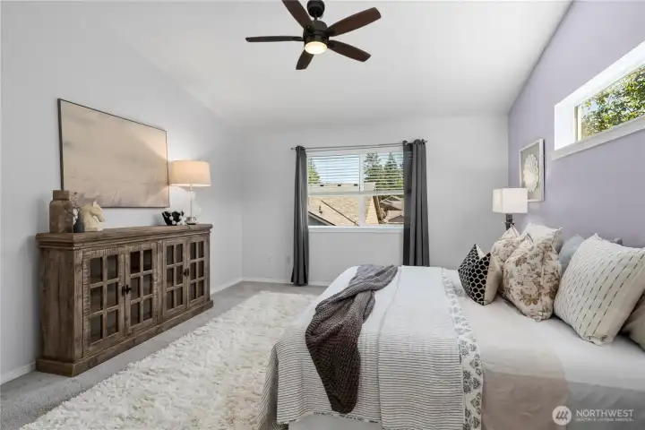 The spacious primary suite provides a peaceful retreat at the end of the day.