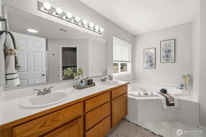 Relax and recharge in the well-appointed primary bathroom, offering both comfort and functionality.