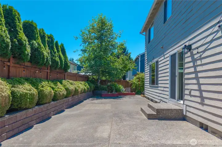 The expansive patio is ready for outdoor dining, summer barbecues, and entertaining.