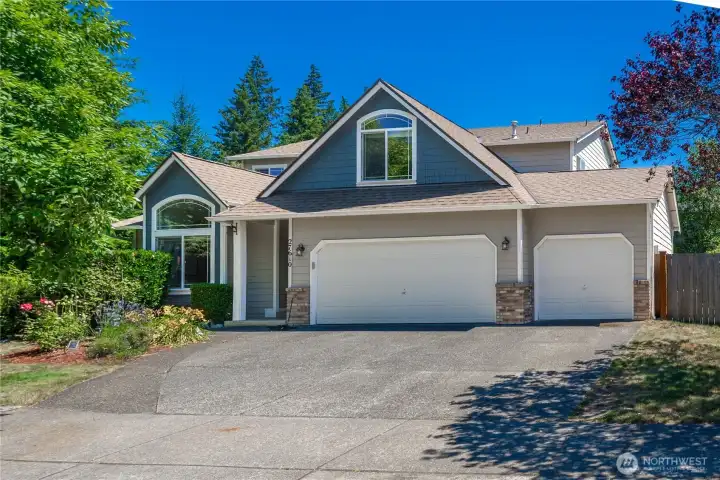 Inviting curb appeal with mature landscaping and a home that's been lovingly cared for.