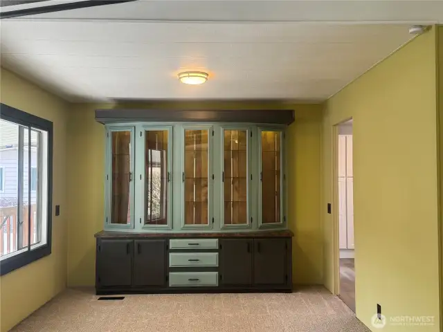 At the far end of the living room you'll find this china cabinet, hutch.