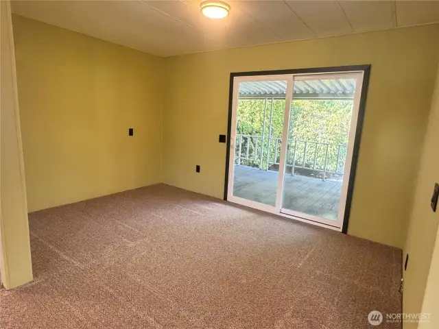 The dining room features a sliding glass view door that opens out to the deck. The deck sits right on the waterfront. Just off the deck is an additional waterfront patio.