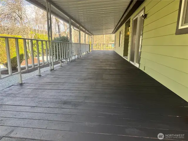 This huge covered deck is right by the waterfront of this home's lot.