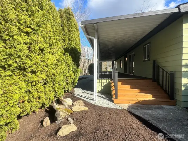 The deck goes the entire length of this home, all the way to the waterfront.