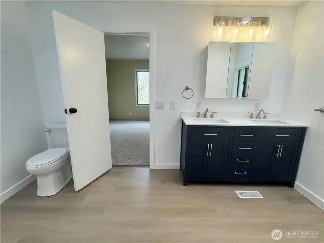 The primary suite's bathroom has a double sink vanity
