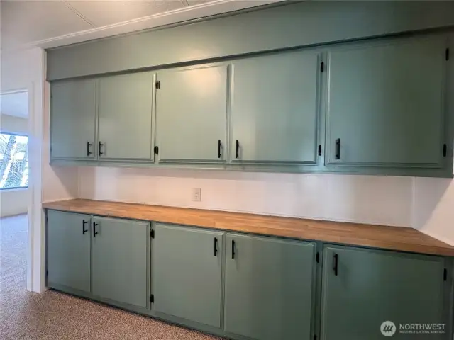 This bank of cabinets is in the hallway. There is storage galore in this home!