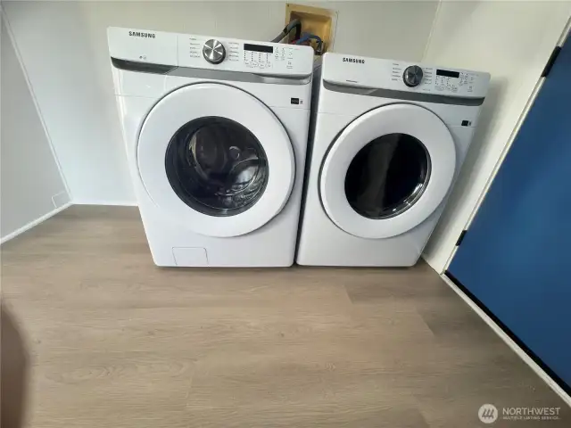 The Laundry room features brand new washer and dryer, and a wall full of cabinets.
