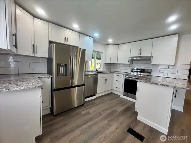 The kitchen has all brand new stainless steel appliances. The quartz countertop, cabinets and all the Luxury Vinyl Plank flooring are also brand new. Plenty of cabinets and countertops make this a chef's dream kitchen.