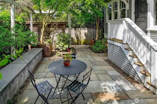 The back patio is well sized for dining al fresco and is enclosed with raised garden beds.