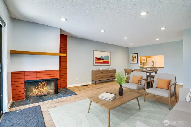 View of corner fireplace and dining area. This is Virtually Staged.