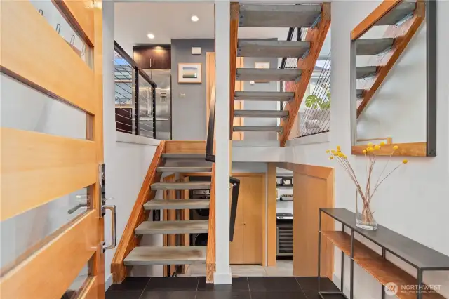 Striking floating staircase anchors the center of the home.