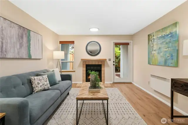 Cozy wood burning fireplace with natural light and private fully fenced patio.